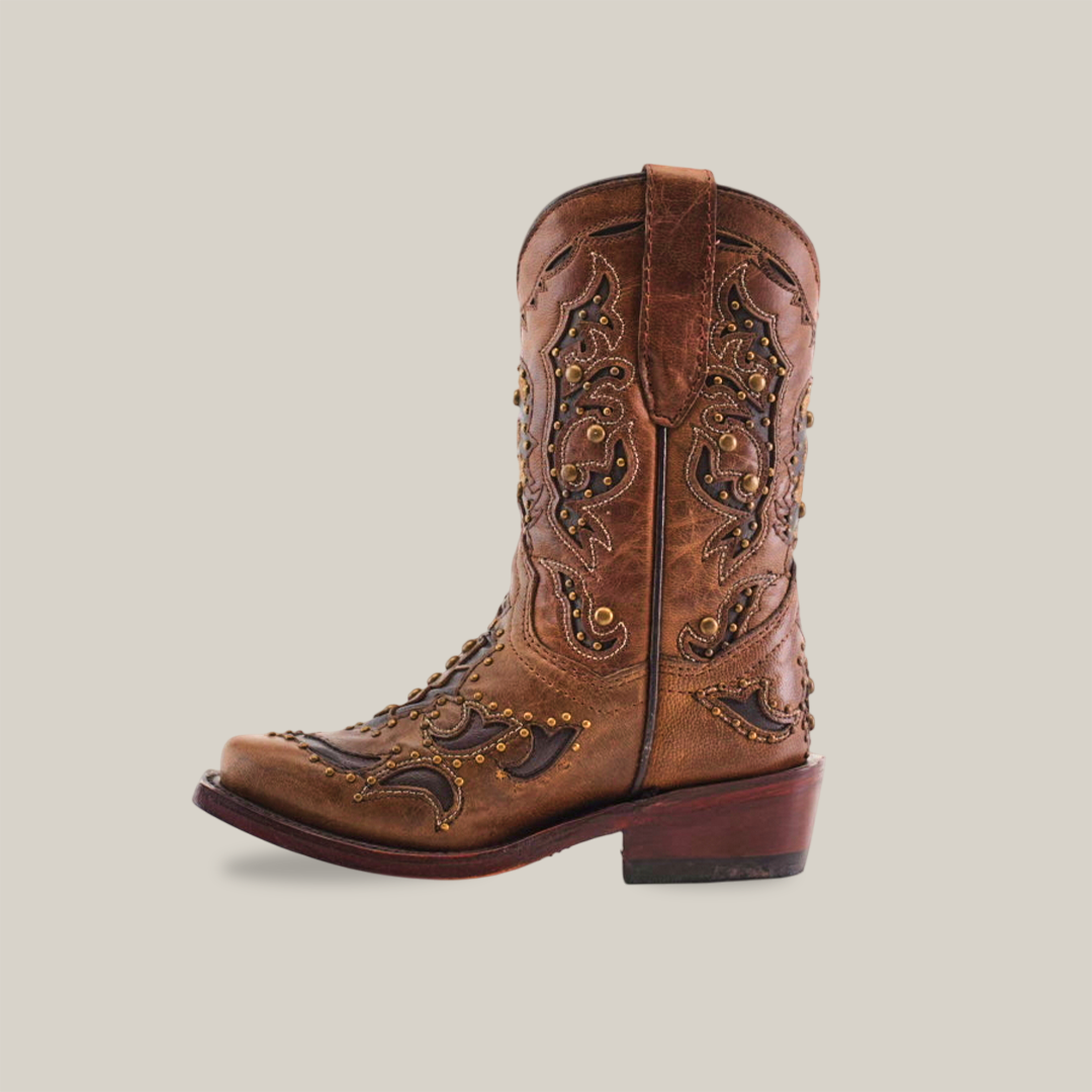 A brown cowhide leather cowboy boot, the Arass Studs Orix - Snip Toe, showcases intricate stitching and decorative studs on a white background. It has a low heel and a pull tab at the top.