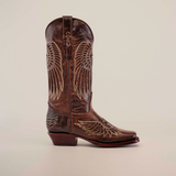 The Texas Cross Glitterbomb Brown boot features a mid-shaft and narrow square toe, expertly crafted with intricate stitching and wing-like patterns on premium brown leather, all highlighted against a plain white background.