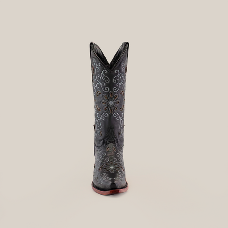 The Alessandria Black Mid Shaft Snip Toe boot, made from premium leather, displays detailed white and brown floral embroidery. Its pointed toe and scalloped top add elegance to the design, highlighting the craftsmanship of these handcrafted boots.