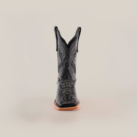 A front-view of a single black leather cowboy boot with intricate patterns and a Caiman Hornback print on the shaft, featuring premium materials, light brown sole, and pointed toe against a plain white background. Product: Caiman Hornback Print Black Square Toe.