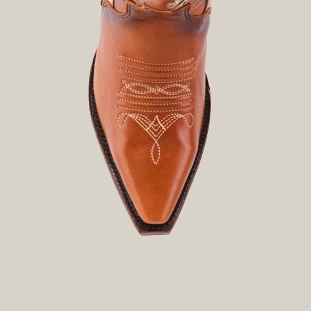 The Valentina Cogñac Tall Shaft boot in premium leather showcases a top view with intricate white stitching on the brown snip toe, all set against a plain white background, exuding Western flair and traditional craftsmanship.