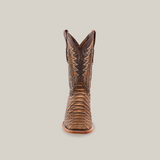 Centered against a plain white background is a single Jumbo Python Print Cappuccino cowboy boot, featuring a square toe, crafted from premium cowhide leather with detailed stitching.