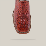 Close-up of the Caiman Hornback Print Cogñac - Square Toe boot, handcrafted with premium cowhide and intricate stitching that mimics luxurious alligator skin, set against a white background.