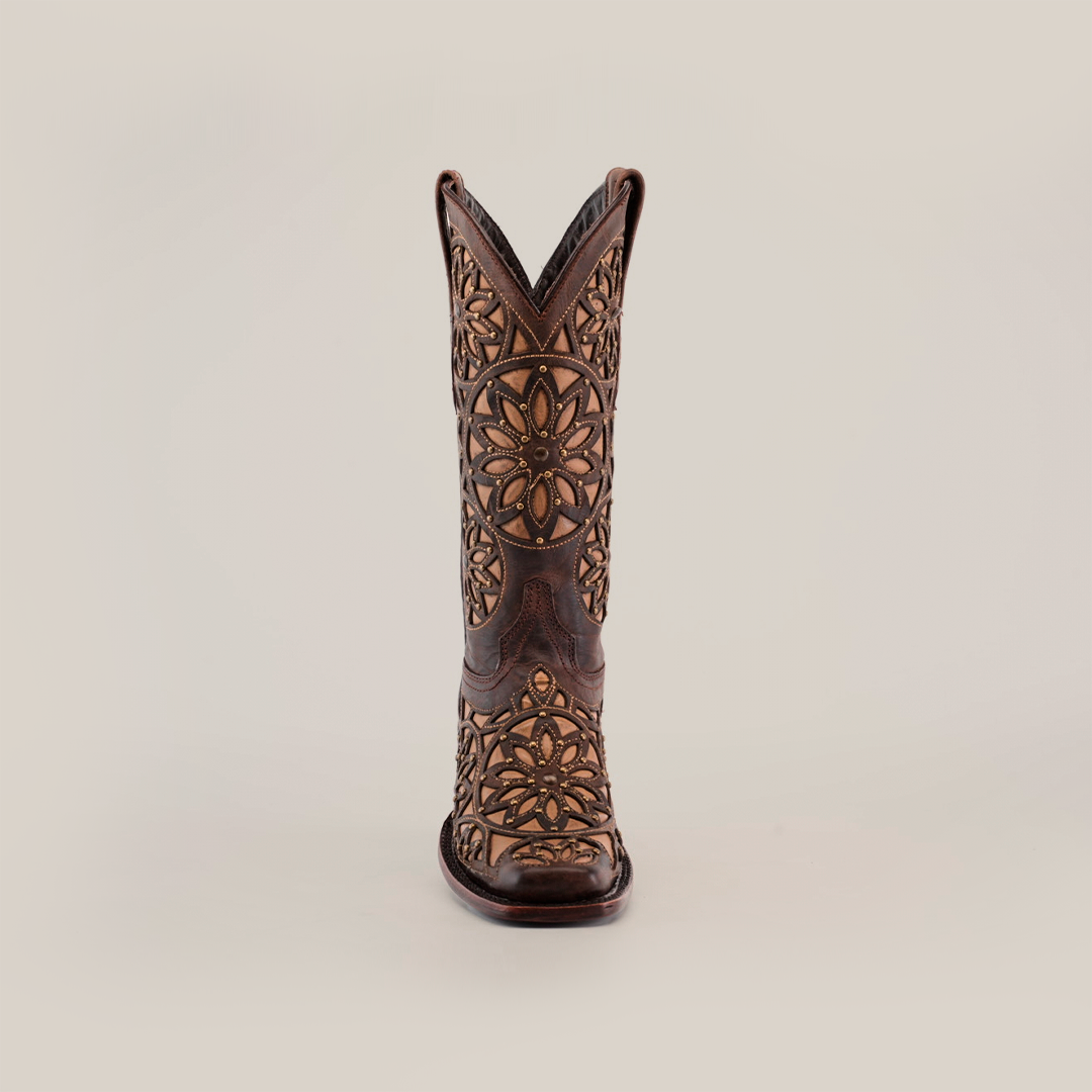 The Vitralli Studs Tabaco cowboy boot, handcrafted from premium leather with intricate floral patterns, takes center stage against a plain white background. Its detailed embroidery lends a decorative and classic Western charm, epitomizing elegance with its mid shaft and narrow square toe design.