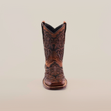 This exquisite Taurine Matte Chocolate - Square Toe boot displays intricate floral patterns on premium leather, highlighting western elegance with its meticulous craftsmanship, all set against a white backdrop.