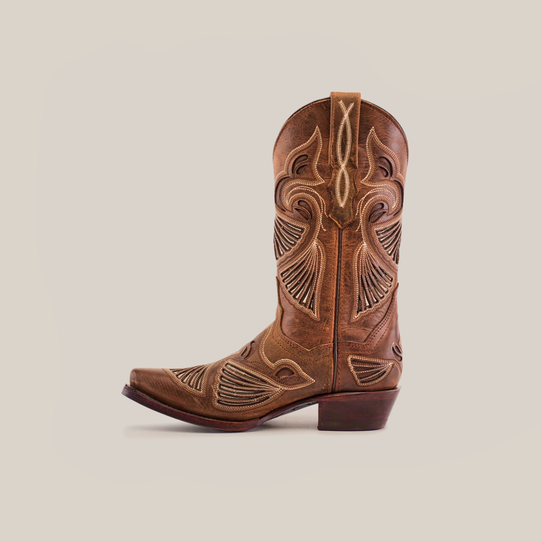 The Shan Camel Short Shaft boot, made of premium leather, features a snip toe, intricate stitching, decorative patterns, stacked heel, and pull strap at the top.