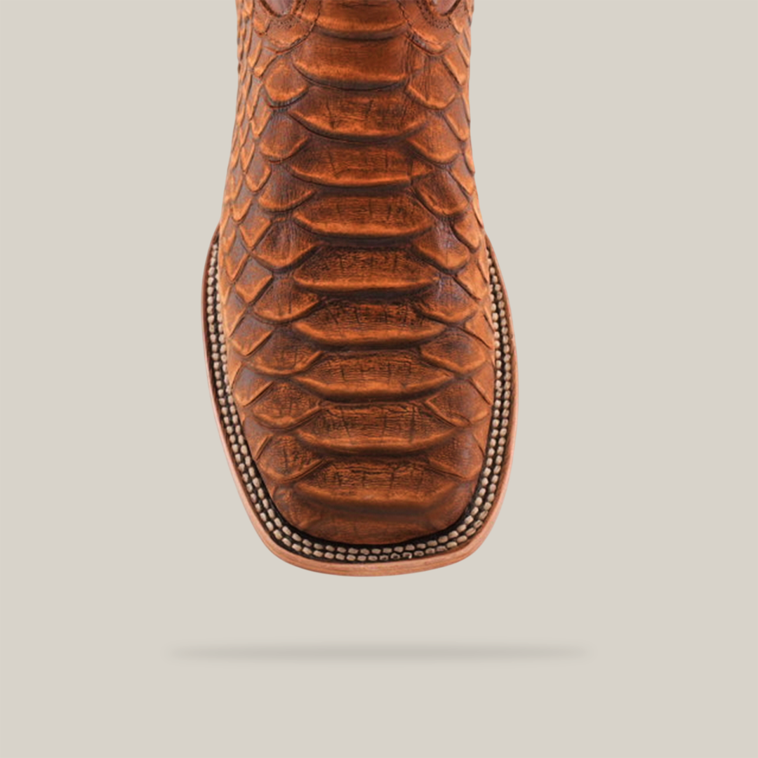 The Jumbo Python Print Cogñac - Square Toe boot, crafted from premium cowhide leather with a python print, features detailed sole stitching and a smooth finish that highlights its elegant yet rugged charm.