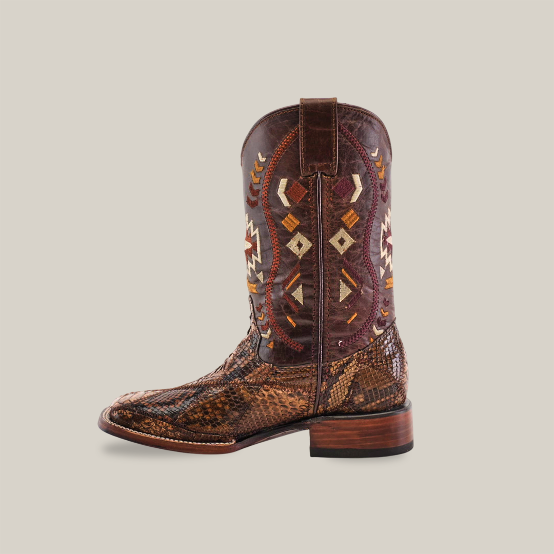 The Exotic Python Patchwork Brown Square Toe boot features a side view showcasing rich brown leather with intricate embroidery and colorful patterns, complemented by a stacked heel and exotic python patchwork, combining classic charm with modern flair.