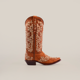 The Cleo Honey Crystals cowboy boot showcases intricate white embroidery in swirls and floral patterns. This handcrafted mid-shaft boot embraces Western style with its snip toe and low heel, elegantly displayed against a plain white background.