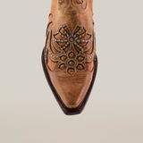 Close-up of the Cotulla Fawn Crystals cowboy boot, a luxurious piece featuring floral embroidery and metal stud details, set against a white backdrop, embodying Western fashion essence.