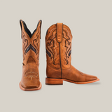 A pair of Wild Mustard - Square Toe cowboy boots in brown, featuring intricate stitching and crafted from premium cowhide. Displayed against a white background, one boot is upright while the other is slightly angled to reveal the elegant design and genuine leather sole.